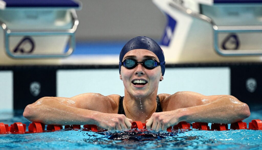 Close-up of Summer McIntosh record performance showing intense effort during final lap of 200m butterfly race in Olympic-style pool